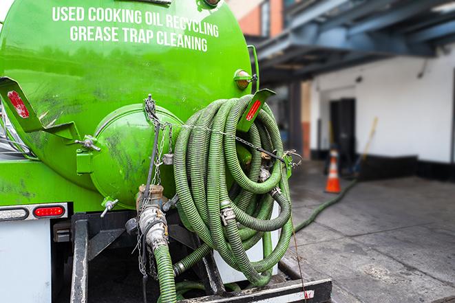 a technician pumping a grease trap in a commercial building in Amawalk NY